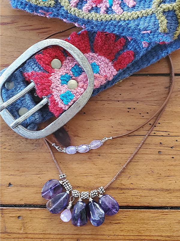 embroidered belt and purple gemstone necklaces