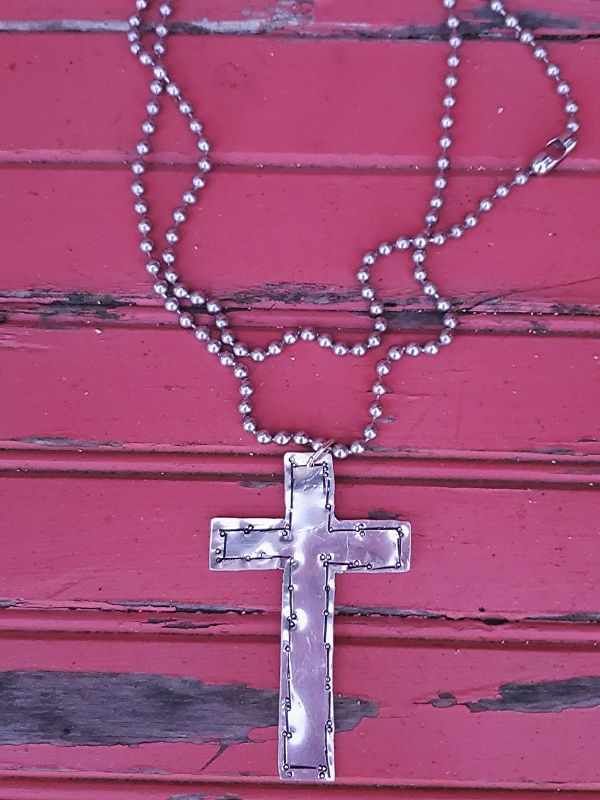 long silver Big cross statement necklace on red wood