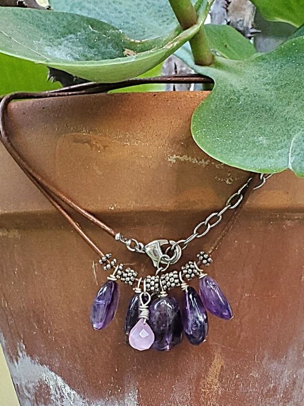purple gemstone cluster necklace on flower pot