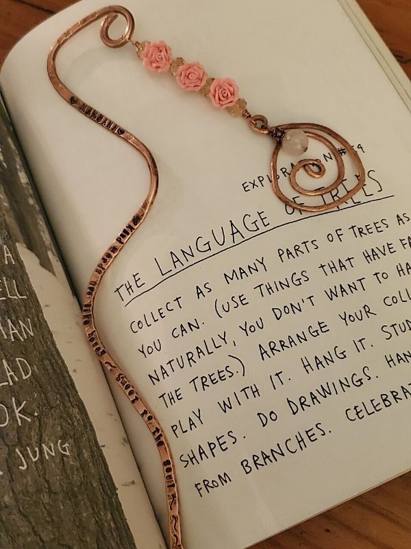 copper jeweled bookmark in open book