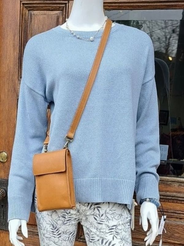 modern pearl necklace on mannequin with blue sweater and leggings