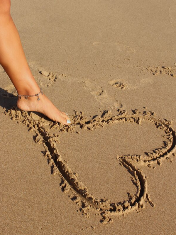 foot by sand heart with heart anklet