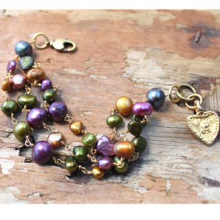 Colorful pearl cluster gold heart bracelet on wood