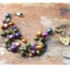 Colorful pearl cluster gold heart bracelet on wood