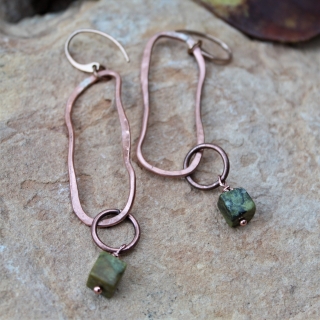 mixed metal organic oval jade earrings on rock