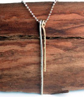 mixed-metal-silver-&-gold-stick-necklace-on-wood-background