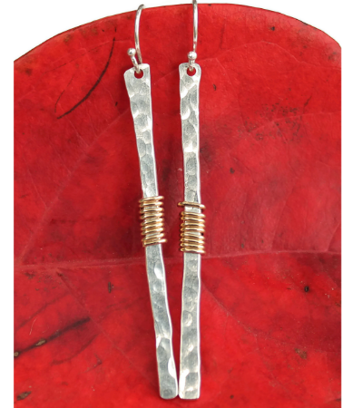 long stick earring on red leaf