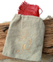 tan-jd-linen-jewelry-bag-red-burlap-liner-on-wood-background