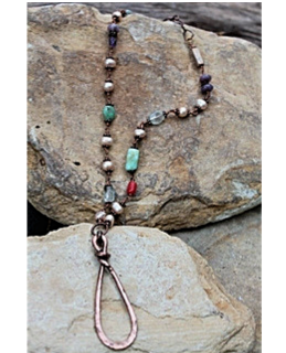 gemstone copper pendant necklace on rocks