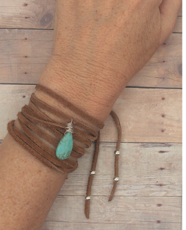 brown suede turquoise wrap bracelet on female wrist