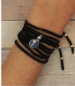 black suede bracelet wrap on wrist on wood