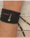 black suede pyrite wrap bracelet on wrist on wood