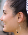 Sterling onyx hoop earrings on female profile