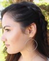 big sterling hoop earring on female profile