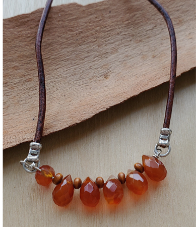 Brown leather orange gemstone necklace on wood