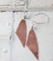 Handcrafted copper & silver earrings on white distressed wood
