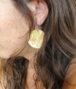 Wearing big round hammered gold disc earrings