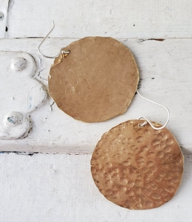  big round hammered gold disc earrings on white distressed trunk