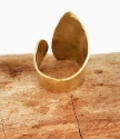 backside of gold wave wrap ring on wood