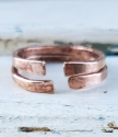 hand forged bronze cuff ring set on white distressed trunk