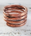 hand forged copper coil ring on white distressed wood