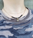 wearing a camo tee with rutilated quartz necklace