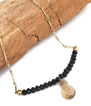 rutialted quartz gold chain necklace on wood