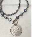 on white wood Portual coin peacock pearl necklace
