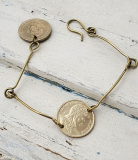 Petite gold or silver coin bracelet on white distressed wood