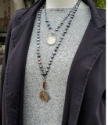 Wearing blue pearl silver coin layered necklaces