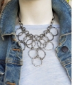 artsy Silver chain bib necklace on mannequin with jean jacket