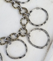 mixed metal chain cluster necklace close up on white distressed wood