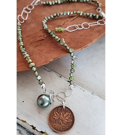 Old 1950 Canada Coin necklace with green pearls on wood