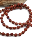close up red gemstone necklace strand