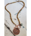 Full view Irish coin pearl necklace on white wood