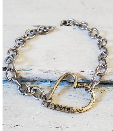 Chunky chain amore heart bracelet on white wood trunk