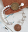 Artisan Old coin bracelet with pearls and chain on wood