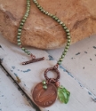 irish coin Green pearl, crystal necklace on rock