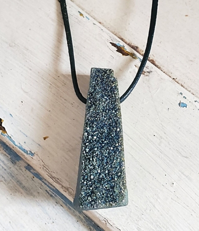 crystal teal druzy leather necklace on white wood