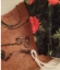 black mask chain attached to mask on wood