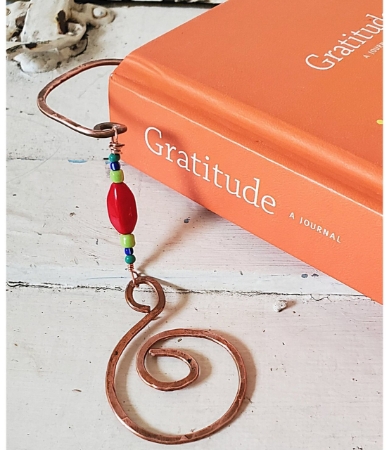 copper spiral beaded book mark in book