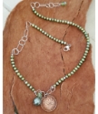 full view Canadian coin green pearl necklace on wood