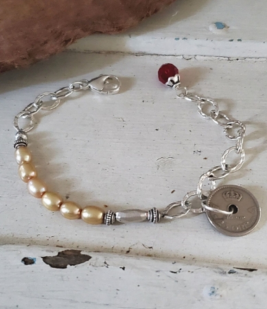 pearl silver chain Norway coin bracelet on white trunk