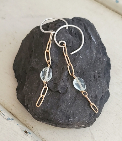 blue stone bronze chain earrings on black rock