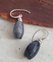 Gray  gemstone earrings on wood
