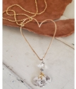 gold Open heart charm necklace on white and wood