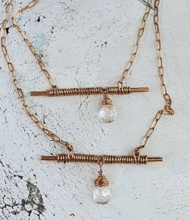 wired wrapped bronze bar crystal chain necklaces on white distressed wood