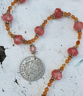 orange pink gemstone silver Guatemalan coin necklace on white