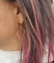 Medium size bronze leaf earrings on model