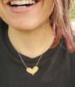 model wearing silver chain small bronze dotted heart necklace